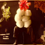 A collage with a persons legs in the center, their body is covered in cotton balls and their face is replaced with a fresh red flower