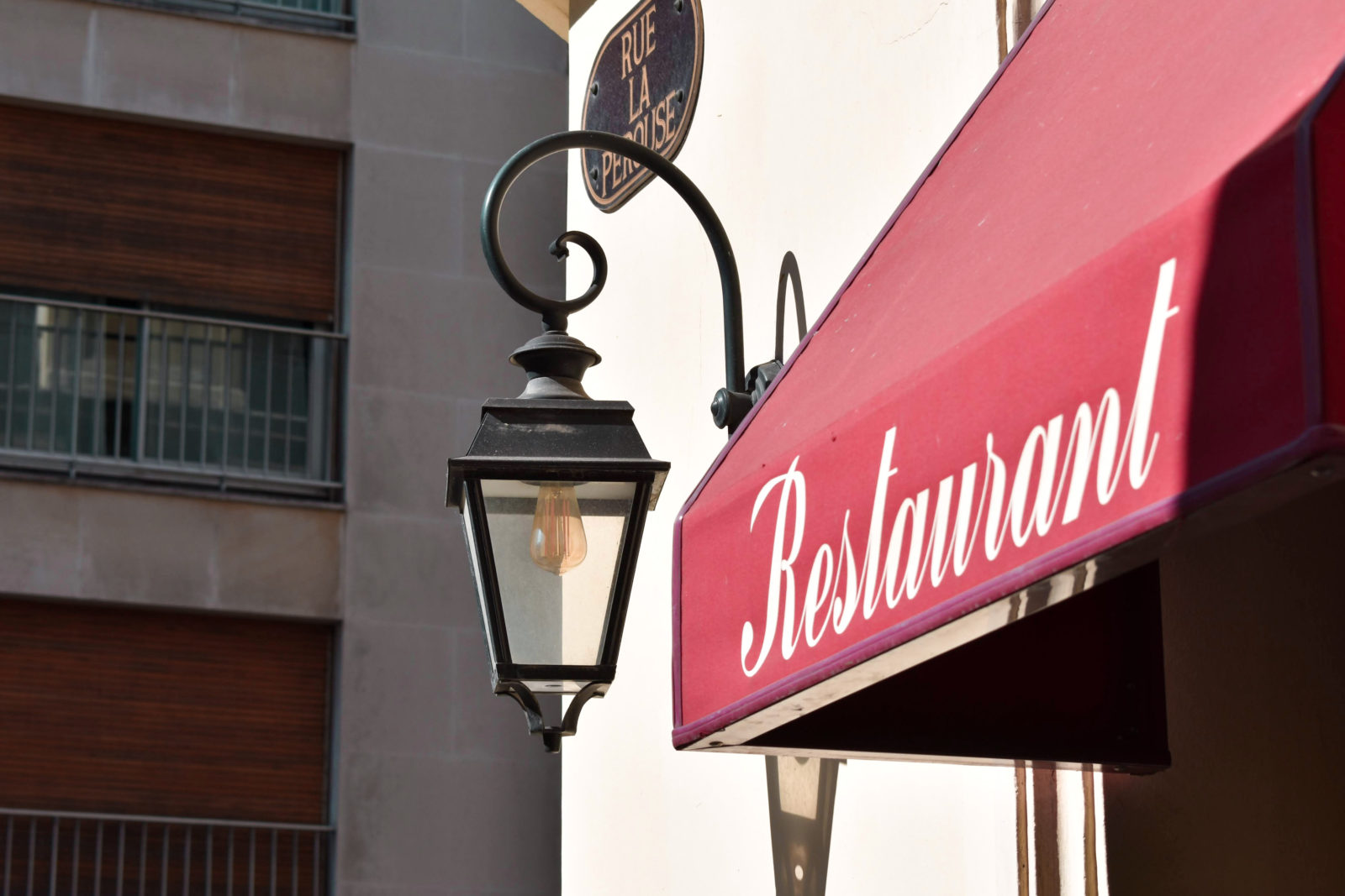 Red awning with the word Restaurant in white script