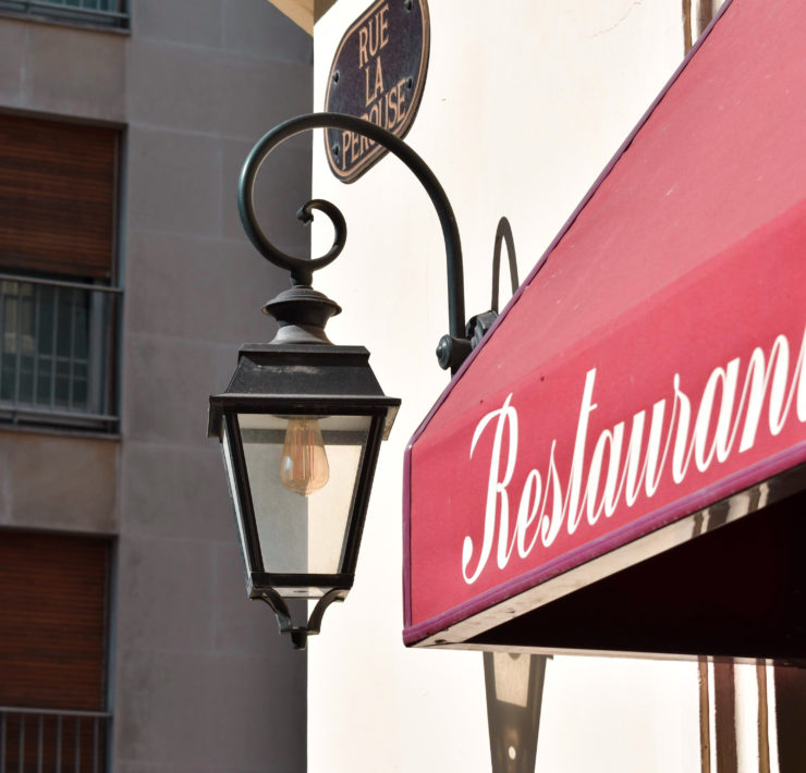 Red awning with the word Restaurant in white script