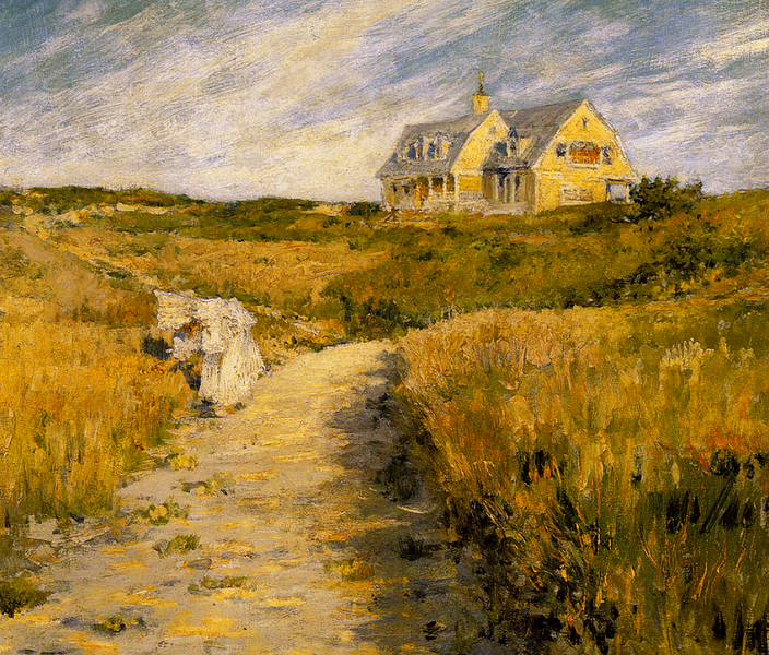 A yellow house in the background on a short hill, surrounded by brown grass
