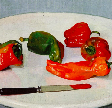 Five peppers on a plate with a knife
