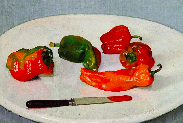 Five peppers on a plate with a knife