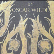 Photo scan of the cover of Salomé by Oscar Wilde, illustrated with gold peacock feathers