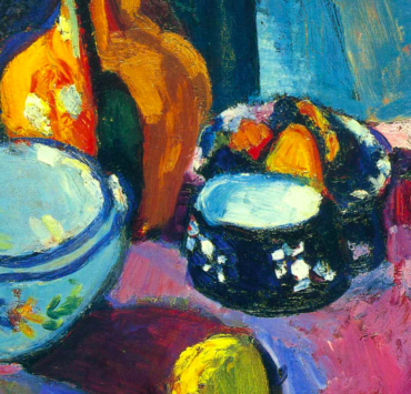 Dishes and Fruit On A Red And Black Carpet