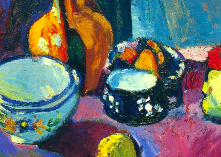 Dishes and Fruit On A Red And Black Carpet
