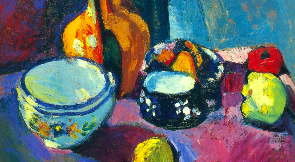 Dishes and Fruit On A Red And Black Carpet