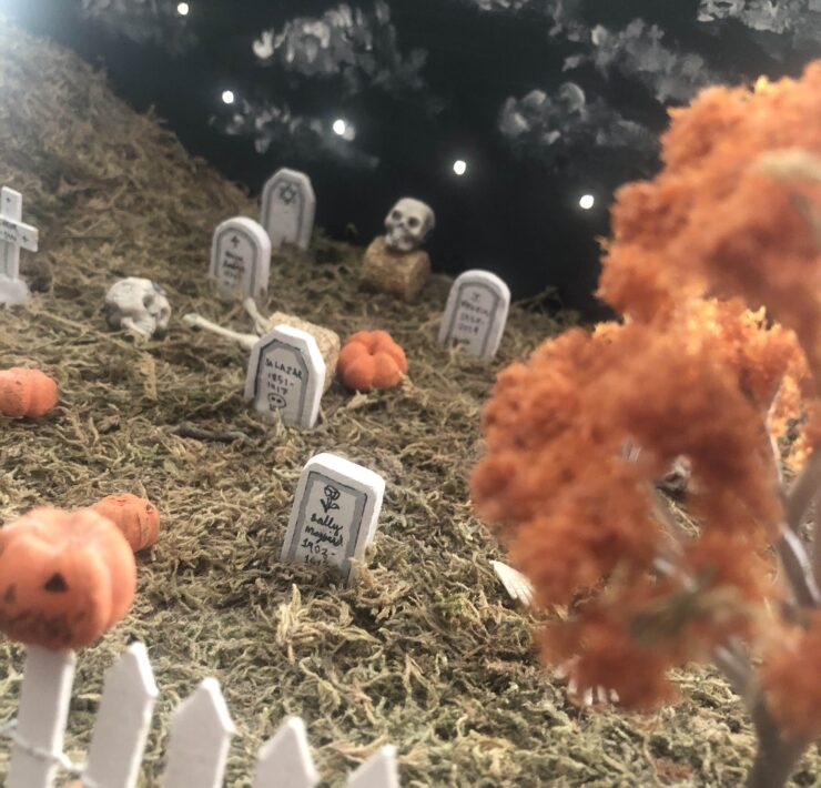 Miniature diorama of a graveyard with autumn trees and pumpkins
