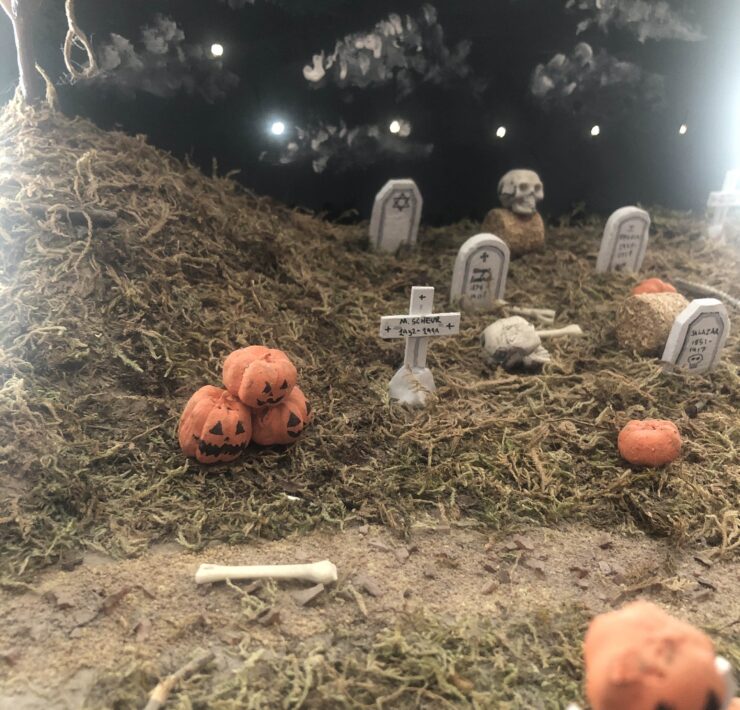 Miniature diorama of a graveyard with autumn trees and pumpkins