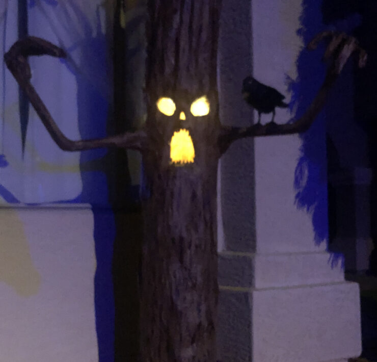 Haunted tree Halloween decoration with glowing eyes and mouth